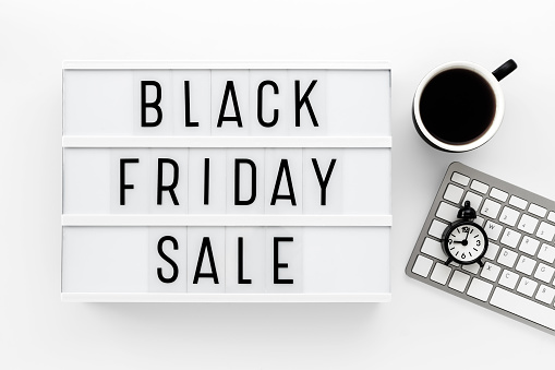 Black Friday sale sign blocks and keyboard and cup