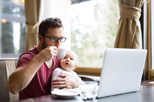 man and baby at laptop