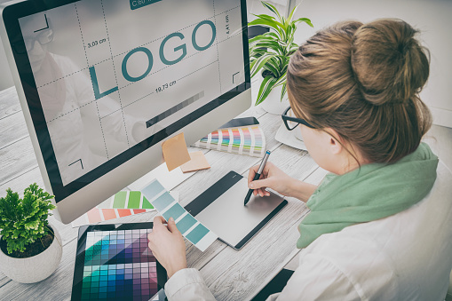 woman designing a logo at pc